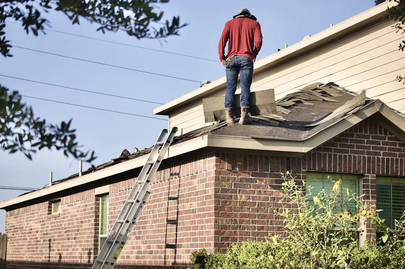 Professional roofer working on a residential roof in Snow Camp